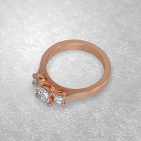 Anello di fidanzamento con 3 pietre che stabilisce la posizione in oro rosa 3d rendering foto