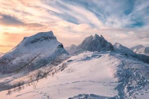 montagna segla con collina innevata nel colorato cielo mattutino all'isola di senja foto