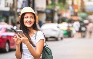 donna asiatica che utilizza smartphone a Khaosan Road foto