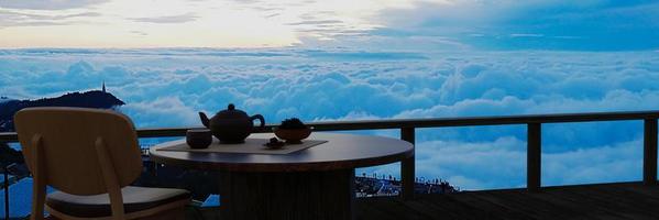 servizio da tè in ceramica e foglie di tè secco su un tavolo e una sedia di legno sul balcone o sulla terrazza in legno. montagna con mare mattutino di nebbia e sole. tè caldo nell'atmosfera di montagna. rendering 3D foto