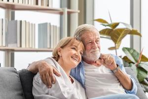 ritratto di felice coppia senior in soggiorno, donna anziana e un uomo che si rilassa sull'accogliente divano a casa, concetti di famiglia felici foto