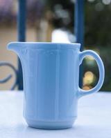tazza blu sul tavolo nel giardino del mattino foto