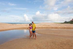coppia matura in piedi sulla spiaggia conosciuta come taipe vicino a arraial d ajuda, biaha, brasile foto
