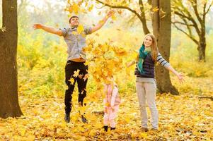 famiglia che cammina nel parco autunnale foto