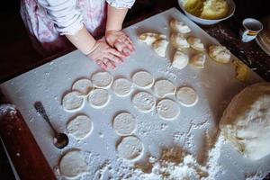 ragazza panettiere in cappello da cuoco in cucina foto