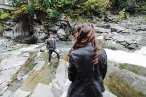 coppia incredibilmente bella e adorabile sullo sfondo di un fiume di montagna foto