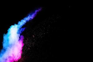 esplosione di polvere blu-rosa astratta su sfondo nero. polvere blu-rosa astratta schizzata su sfondo scuro foto
