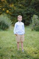 un bambino in età scolare corre con i palloncini. il ragazzo festeggia il suo compleanno nel parco. foto