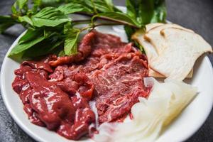 set di carne fetta di manzo fegato e funghi verdure per cibi giapponesi cotti o sukiyaki shabu shabu foto