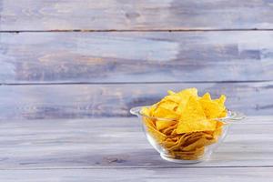 nachos messicani con formaggio. chips di mais isolato su sfondo di legno foto
