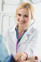 medico di medicina femminile che misura la pressione sanguigna