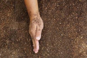 gli agricoltori mescolano il terreno per coltivare. fornisce i minerali di cui le piante hanno bisogno cresce velocemente e forte. foto