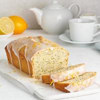 pane al limone ricoperto di glassa dolce di zucchero e cosparso di scorza di limone. fetta di torta agli agrumi foto