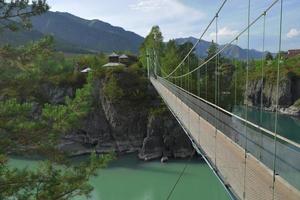 ponte sospeso sul fiume di montagna foto