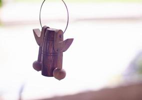 campana di legno fatta a mano appesa alle finestre di casa. foto