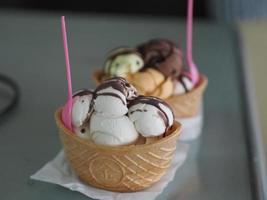 cioccolato, tè tailandese all'arancia, gelato al latte di cocco in una tazza di cialda croccante sul tavolo a specchio foto