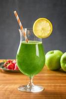frullato verde in un bicchiere da cocktail foto