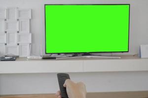 guardare la tv, cambiare canale con il telecomando foto