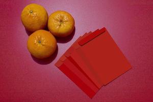concetto di capodanno cinese - mandarini e pacchetto rosso foto