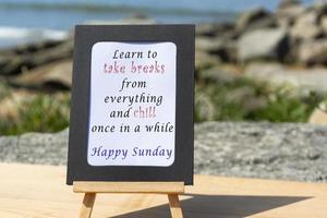 citazione motivazionale e ispiratrice su un blocco note con sfondo sfocato sulla spiaggia foto