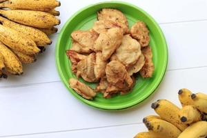 vista dall'alto frittella di banana fatta in casa o pisang goreng o banana fritta, piatto tradizionale indonesiano a base di banana con rivestimento di pastella di farina e fritto, copia spazio per il testo foto