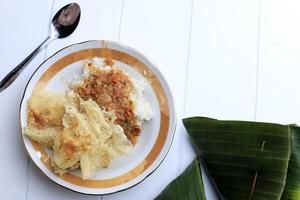 vista dall'alto nasi sambal tumpang con peyek, piatto tradizionale di kediri, java orientale. servito su piatto di ceramica con copia spazio foto