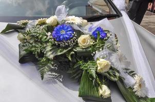 bouquet di fiori su un'auto alla cerimonia di nozze foto