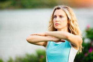 yoga. giovane donna che fa esercizio di yoga all'aperto foto