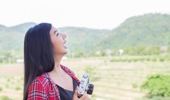 fotografo di giovane donna hipster in possesso di una macchina fotografica d'epoca. foto