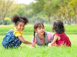 un gruppo di bambini di diverse nazionalità giocano e imparano al di fuori della scuola foto