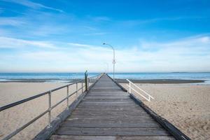 la passerella in legno e la vista panoramica della spiaggia di altona vicino alla città di melbourne, australia. foto