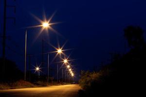 accendi una lampada sulla strada nell'oscurità. foto