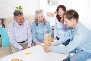 coppia di anziani con il primo piano della famiglia che fa una piramide con cubi di legno vuoti da vicino foto