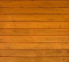 sfondo e struttura della parete di finitura della copertura in legno realizzata in legno di teak sulla parete della casa. foto