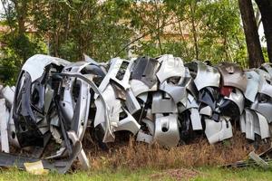 molti paraurti per auto vicino ad alberi rurali. foto