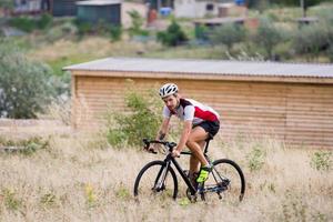 ciclista su bici da ciclocross allenamento all'aperto su strada di campagna sterrata foto