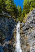 piccola caduta d'acqua nella foresta delle alpi, davos, grigioni, svizzera foto