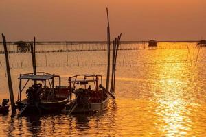 bellissimo tramonto sul mare. cielo e nuvole al tramonto scuri e dorati. sfondo della natura per un concetto tranquillo e pacifico. tramonto a chonburi, in tailandia. foto d'arte del cielo al tramonto. agricoltura in mare.