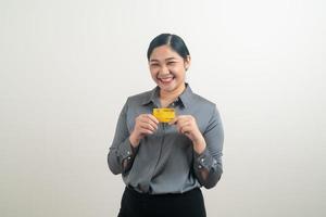 donna asiatica in possesso di carta di credito con sfondo bianco foto