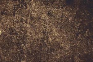 superficie in pietra di granito color nocciola scuro antico della grotta per interni foto