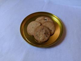 biscotti all'uvetta cosparsi di zucchero in cima su un piatto dorato foto