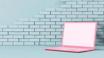 laptop rosa in camera blu con decorazione minimale e muro di mattoni. computer di simulazione. foto