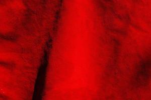 sfondo rosso opaco di pelle scamosciata. struttura vellutata di pelle senza cuciture. struttura in pelle scamosciata rossa. foto