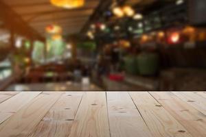 tavolo vuoto di fronte a una caffetteria sfocata o a un ristorante caffetteria con sfondo astratto pronto per creare un'esposizione di prodotti di montaggio o progettare un banner o una panoramica del layout visivo chiave foto