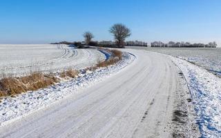 strada di campagna coperta di neve in una giornata di sole in germania. foto