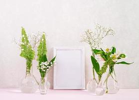 fiori e piante in fiaschetta con cornice. bellissimo sfondo primaverile con fiori in vaso. foto
