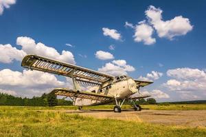 vecchio aereo distrutto nel campo in una giornata di sole foto