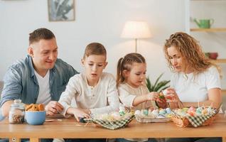 quattro persone. famiglia felice che celebra insieme le vacanze di pasqua foto