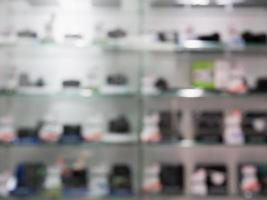 le fotocamere digitali e gli obiettivi nello scaffale del negozio di fotocamere sfocano lo sfondo foto