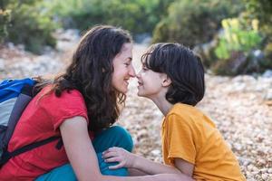 un ragazzo abbraccia sua madre, gli abbracci della madre foto